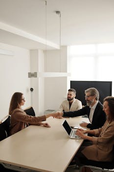 Lawyer shaking hands with new client in office