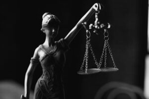 Metal scales of justice on wooden table