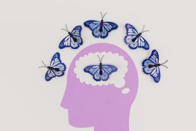 A human brain illustration with blue butterflies around it