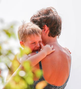 Child leaning on parent's shoulder, symbolizing emotional safety