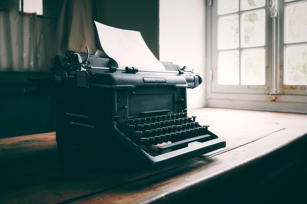 Vintage typewriter on a dark desk, symbolizing the return to voice and power.